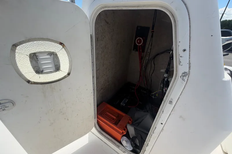 Slide: The Image of Open storage compartment on a 2005 Sea Fox 197 Center Console boat, showing wiring and equipment. - 22