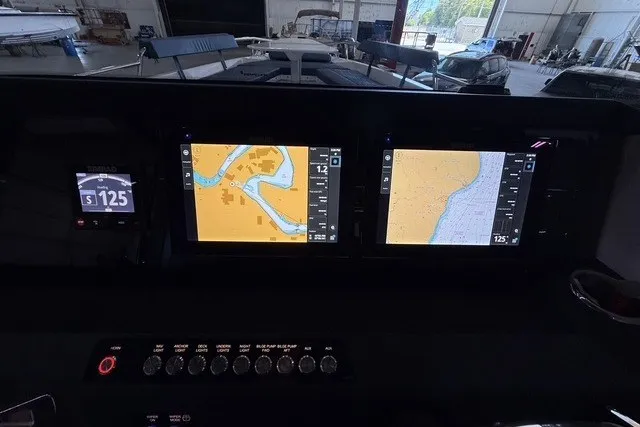 Slide: The Image of 2025 Axopar 29 XC Cross Cabin dashboard with navigation screens and controls. - 20