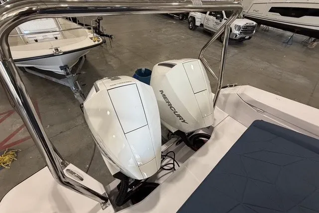 Slide: The Image of 2025 Axopar 29 XC Cross Cabin with dual Mercury outboard engines in a showroom. - 7