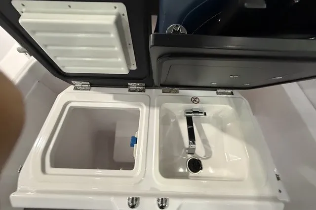 Slide: The Image of 2025 Axopar 29 XC Cross Cabin sink and storage compartment detail. - 23