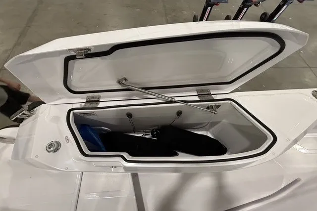 Slide: The Image of Open storage compartment on 2025 Axopar 29 XC Cross Cabin boat. - 13