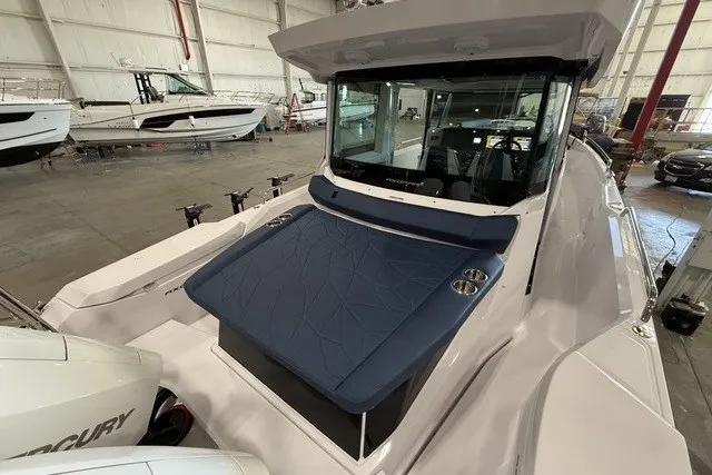 Slide: The Image of 2025 Axopar 29 XC Cross Cabin boat in a showroom, featuring a sleek design and modern amenities. - 8