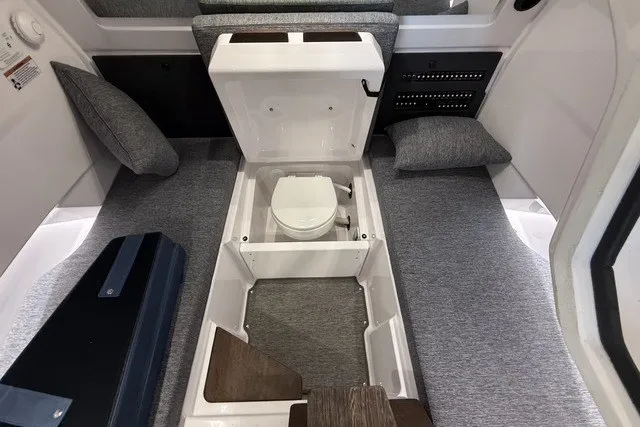 Slide: The Image of 2025 Axopar 29 XC Cross Cabin interior with hidden toilet compartment. - 26