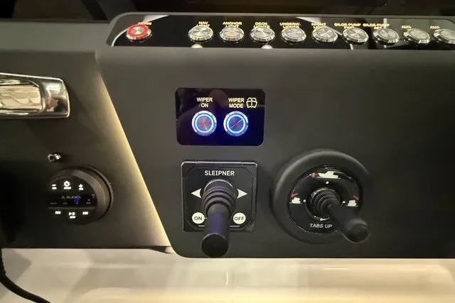Slide: The Image of Control panel of 2025 Axopar 29 XC Cross Cabin with wiper and tab controls. - 19