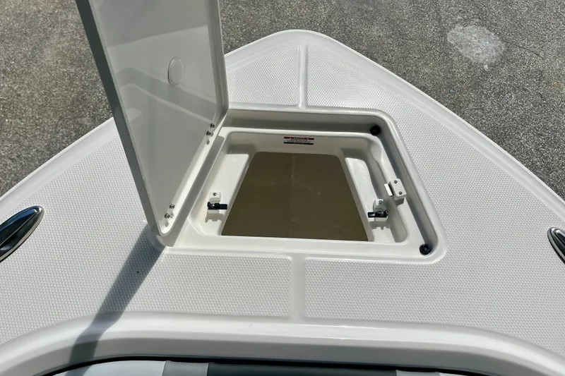 Slide: The Image of Open storage compartment on 2027 Robalo R230 Center Console boat deck. - 29