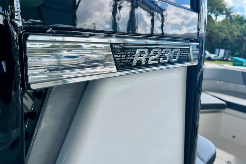 Slide: The Image of 2027 Robalo R230 Center Console boat emblem, showcasing sleek design and modern features. - 33