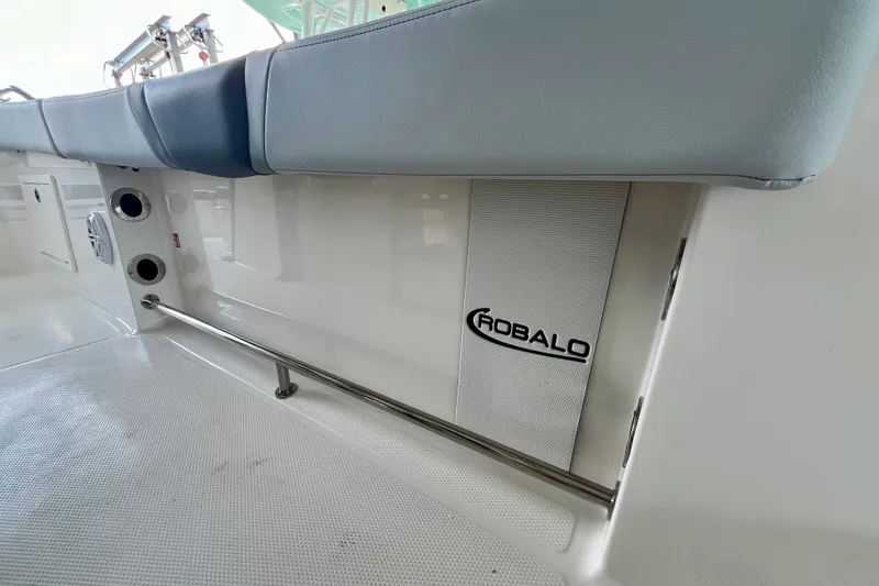 Slide: The Image of 2027 Robalo R230 Center Console interior with cushioned seating and branded panel. - 31