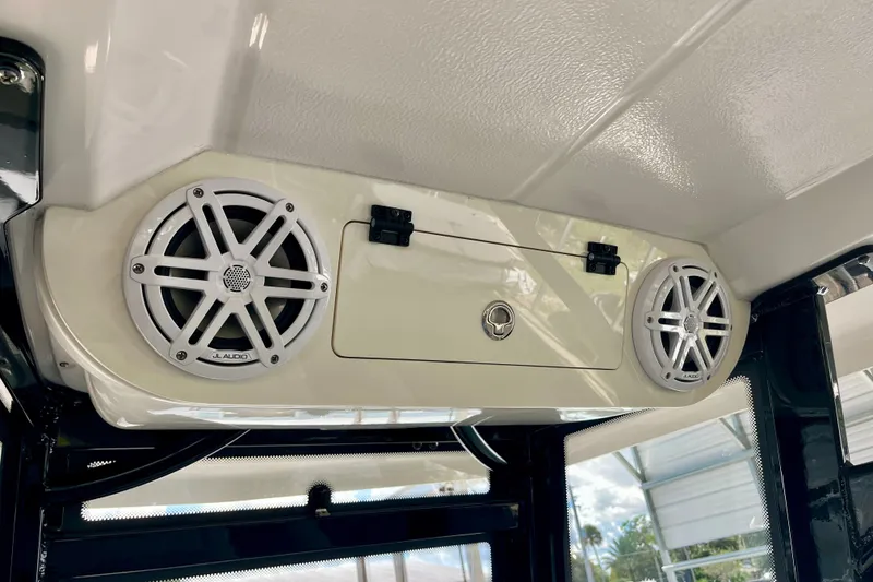 Slide: The Image of 2027 Robalo R230 Center Console boat speakers and storage compartment detail. - 19