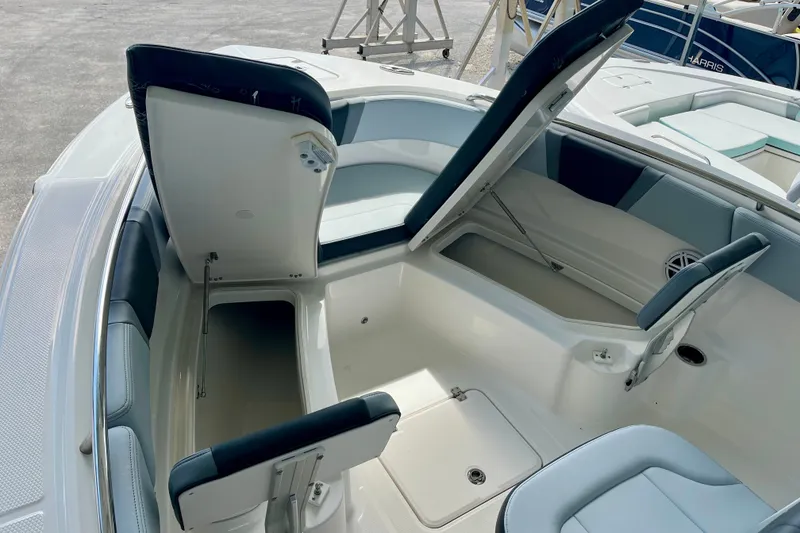 Slide: The Image of 2027 Robalo R230 Center Console boat with open storage compartments and seating. - 26