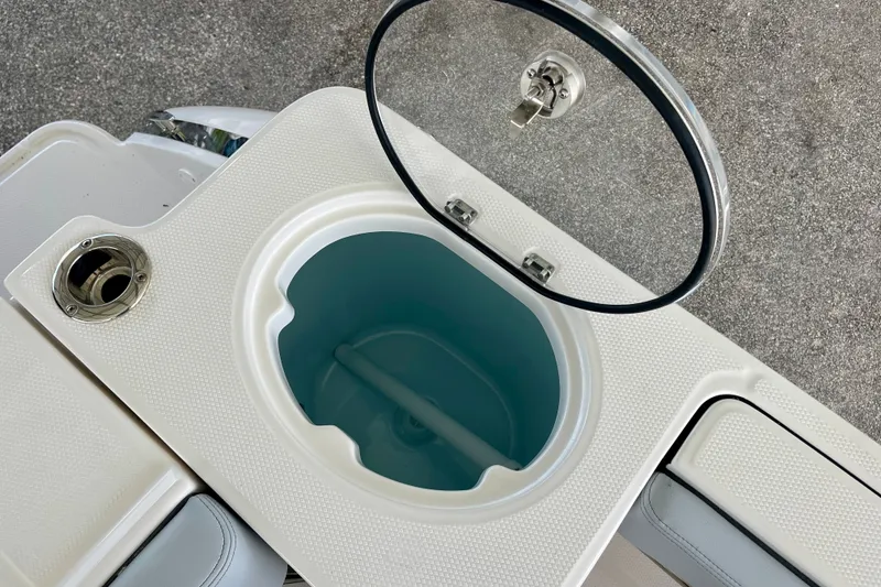 Slide: The Image of 2027 Robalo R230 Center Console livewell with open lid, showcasing interior design. - 14
