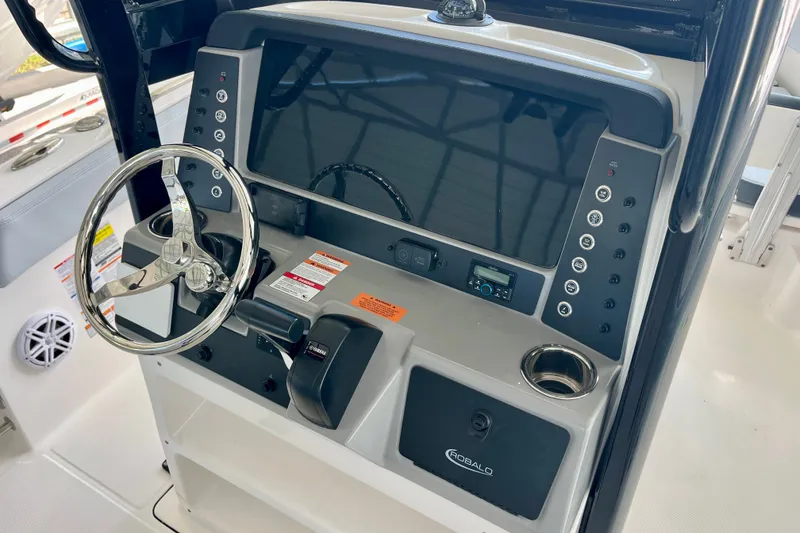 Slide: The Image of 2027 Robalo R230 Center Console dashboard with steering wheel and control panel. - 23