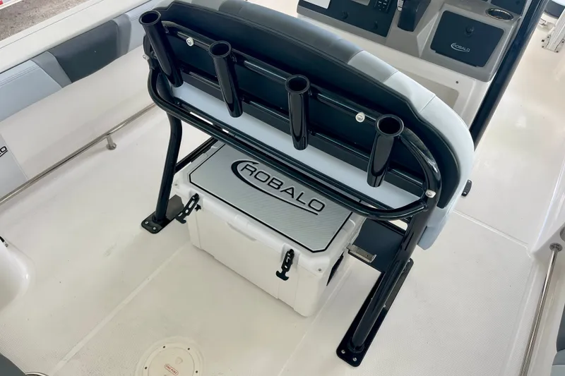 Slide: The Image of 2027 Robalo R230 Center Console boat interior with rod holders and storage compartment. - 15
