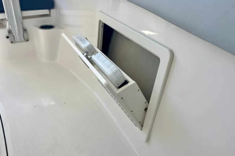 Slide: The Image of 2027 Robalo R230 Center Console boat storage compartment detail. - 32