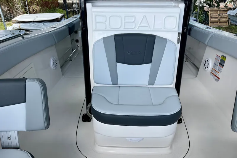 Slide: The Image of 2027 Robalo R230 Center Console boat interior with cushioned seating and sleek design. - 27