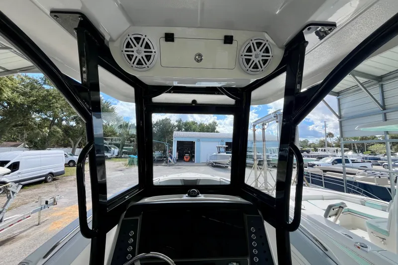 Slide: The Image of 2027 Robalo R230 Center Console boat interior with speakers and control panel. - 18
