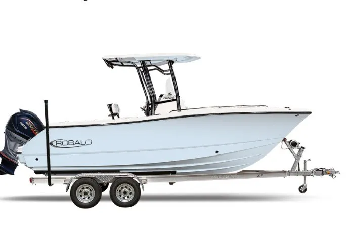 The Image of 2027 Robalo R230 Center Console boat on trailer, side view, white hull, dual engines. - 1