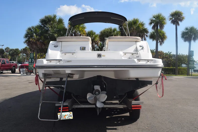 Slide: The Image of 2005 Sea Ray SLX 280 boat on trailer, parked with palm trees in the background. - 4