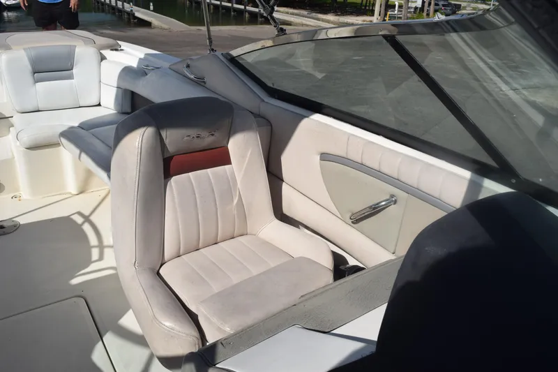 Slide: The Image of 2005 Sea Ray SLX 280 boat interior with beige seating and windshield. - 27