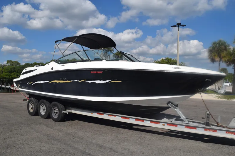 Slide: The Image of 2005 Sea Ray SLX 280 boat on trailer under blue sky with clouds. - 1