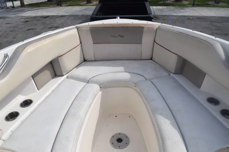 Slide: The Image of 2005 Sea Ray SLX 280 boat interior with white seating and cup holders. - 20