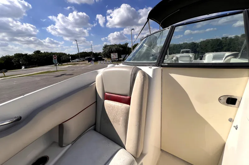 Slide: The Image of 2005 Sea Ray SLX 280 boat interior with seating, under a partly cloudy sky. - 24
