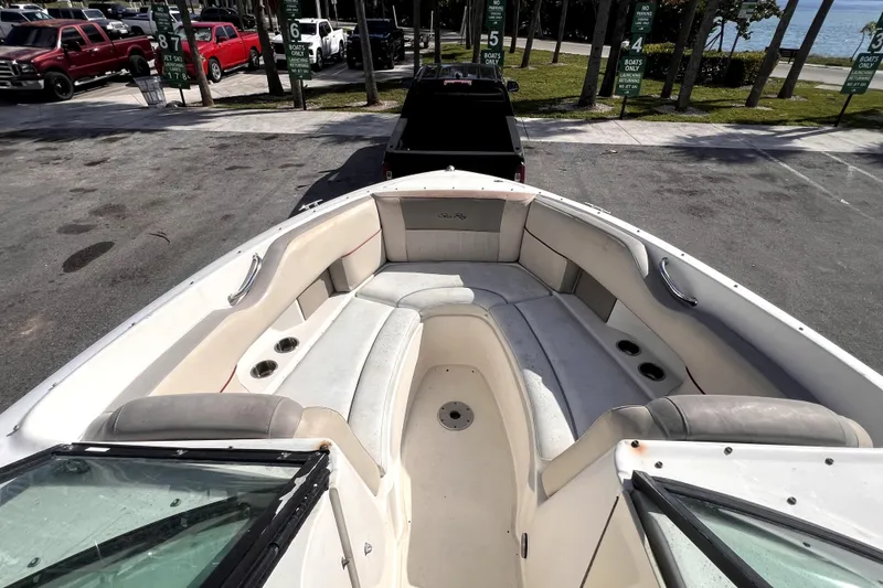 Slide: The Image of 2005 Sea Ray SLX 280 boat interior with spacious seating and cup holders. - 19