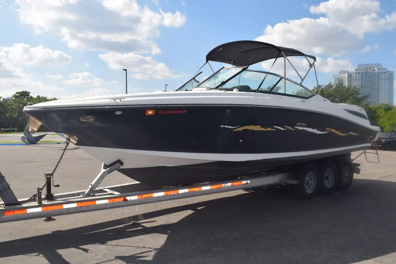Slide: The Image of 2005 Sea Ray SLX 280 boat on trailer under clear sky. - 7
