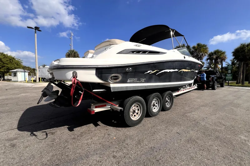 Slide: The Image of 2005 Sea Ray SLX 280 boat on trailer under clear blue sky. - 3