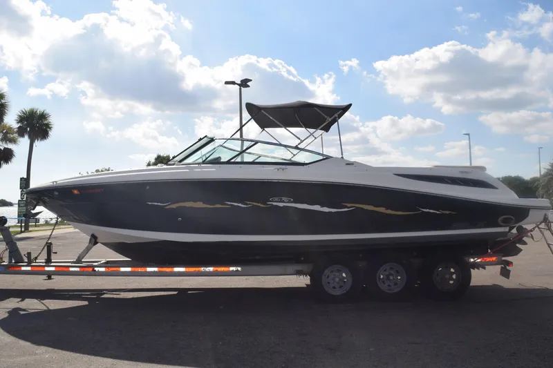 Slide: The Image of 2005 Sea Ray SLX 280 boat on trailer under a sunny sky. - 6