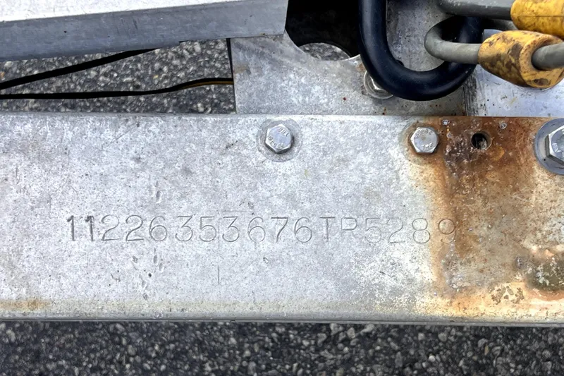 Slide: The Image of Close-up of a metal boat trailer with engraved serial number, Sea Ray SLX 280, 2005. - 41