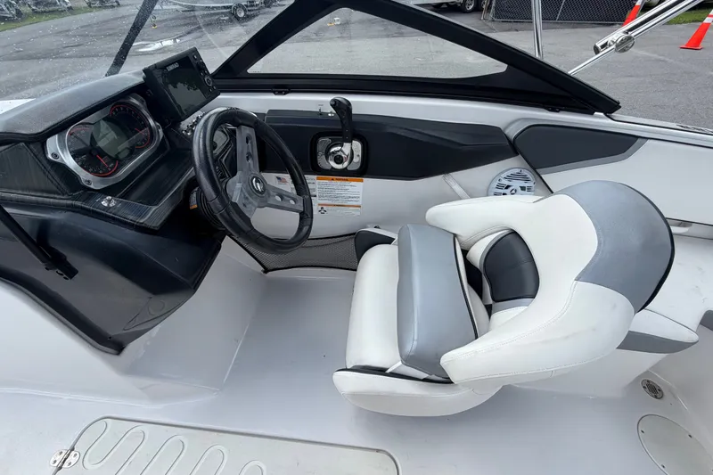 Slide: The Image of Interior of a 2018 Scarab 195 G boat showing steering wheel and dashboard controls. - 19