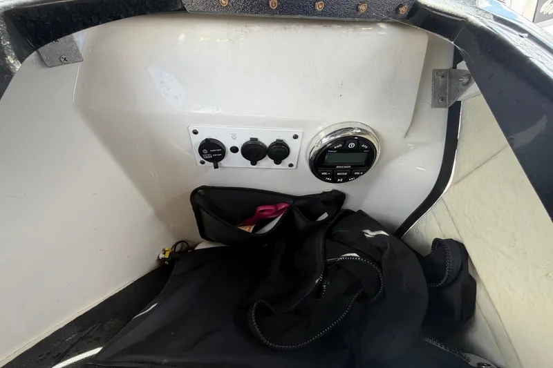Slide: The Image of Control panel of a 2018 Scarab 195 G boat with storage compartment. - 32