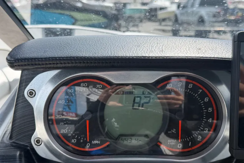 Slide: The Image of Dashboard of a 2018 Scarab 195 G boat showing speedometer and tachometer. - 23