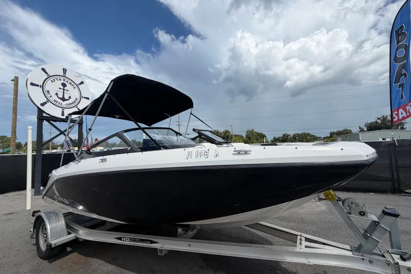 The Image of 2018 Scarab 195 G boat on trailer under cloudy sky at sales lot. - 0