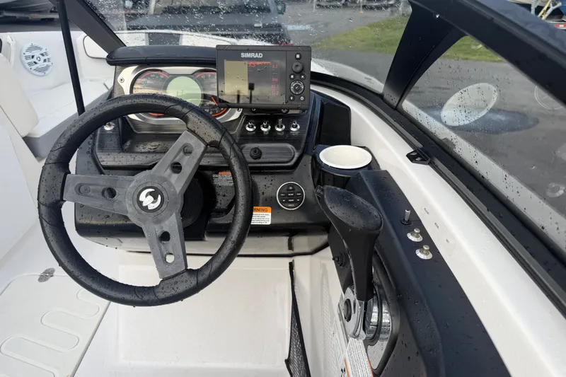 Slide: The Image of Cockpit view of 2018 Scarab 195 G boat with steering wheel and control panel. - 4