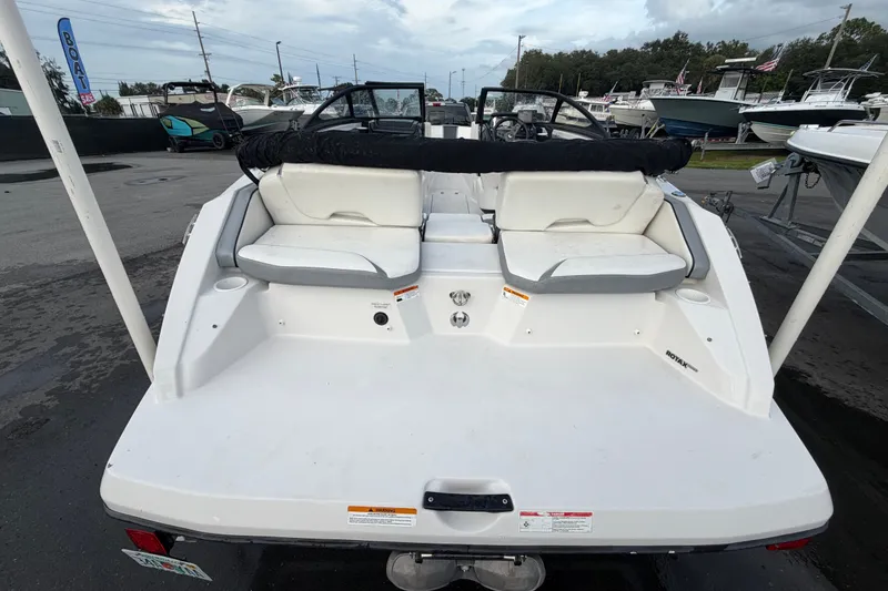 Slide: The Image of 2018 Scarab 195 G boat rear view with seating and storage compartments. - 2