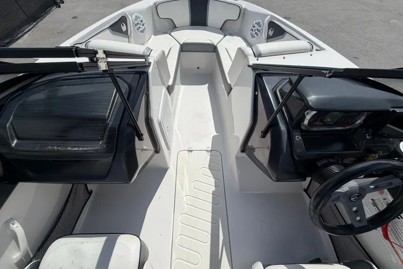 Slide: The Image of Interior view of a 2018 Scarab 195 G boat, featuring seating and dashboard. - 33