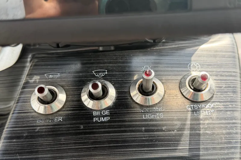 Slide: The Image of Control panel of a 2018 Scarab 195 G boat with labeled switches. - 26