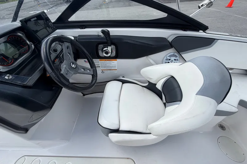 Slide: The Image of Interior of a 2018 Scarab 195 G boat featuring steering wheel and control panel. - 20