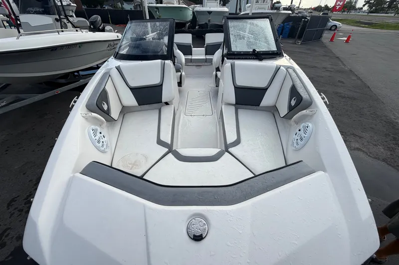 Slide: The Image of 2018 Scarab 195 G boat interior with dual windshields and seating, parked on a trailer. - 3