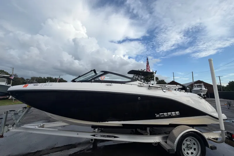 Slide: The Image of 2018 Scarab 195 G boat on trailer under cloudy sky. - 1