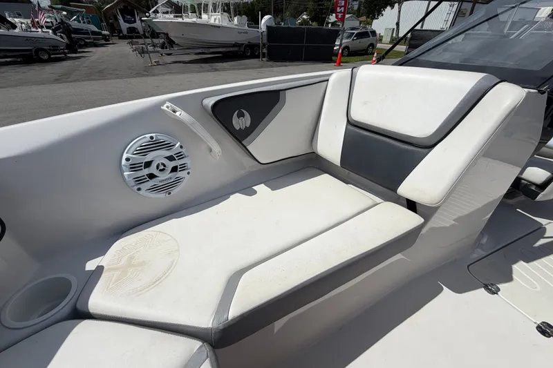 Slide: The Image of Interior seating of a 2018 Scarab 195 G boat with speaker and cup holder. - 41