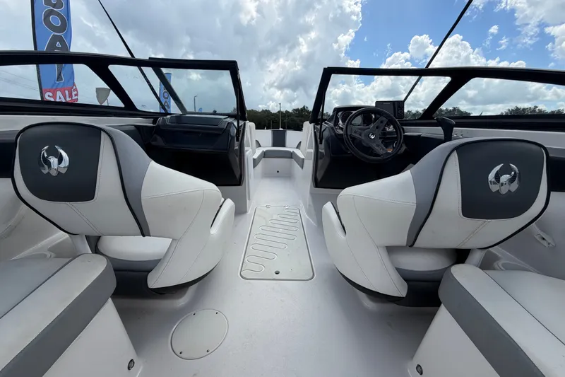 Slide: The Image of Interior view of 2018 Scarab 195 G boat with white seating and steering wheel. - 15