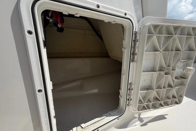 Slide: The Image of Open storage compartment on a 2018 Scarab 195 G boat. - 36