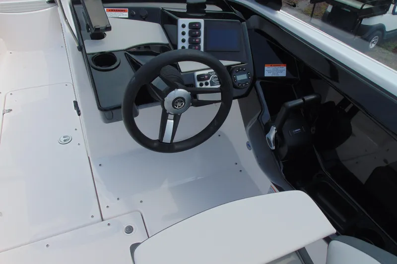 Slide: The Image of 2026 Yamaha Boats SX220 cockpit with steering wheel, control panel, and seating area. - 12