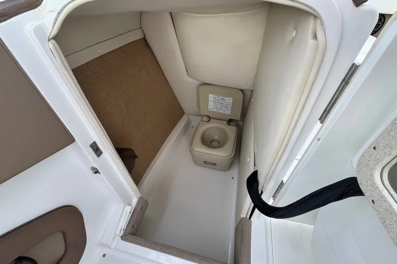 Slide: The Image of 2012 Cobalt 262 WSS boat interior with compact marine toilet. - 38