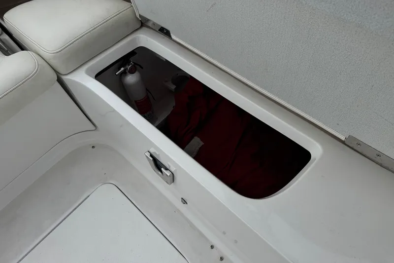 Slide: The Image of Storage compartment in a 2012 Cobalt 262 WSS boat with fire extinguisher. - 33