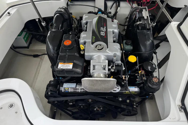 Slide: The Image of Engine compartment of a 2012 Cobalt 262 WSS boat, featuring an 8.2L MerCruiser engine. - 28
