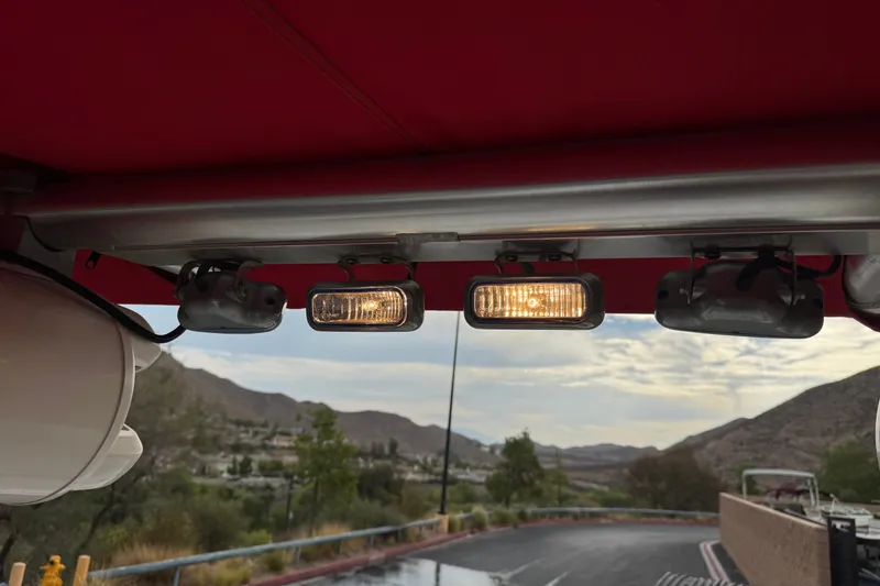 Slide: The Image of Interior view of a 2012 Cobalt 262 WSS boat with overhead lights and scenic mountain backdrop. - 22