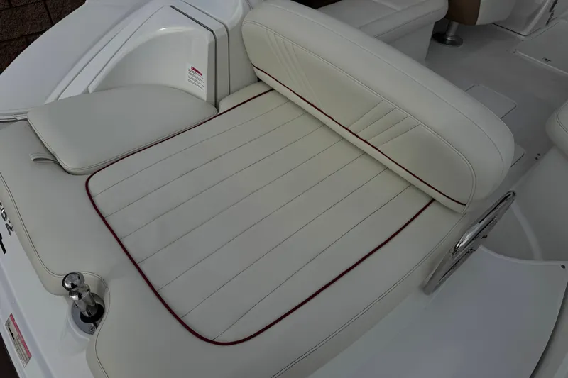 Slide: The Image of White leather seating on a 2012 Cobalt 262 WSS boat, featuring red accents. - 8